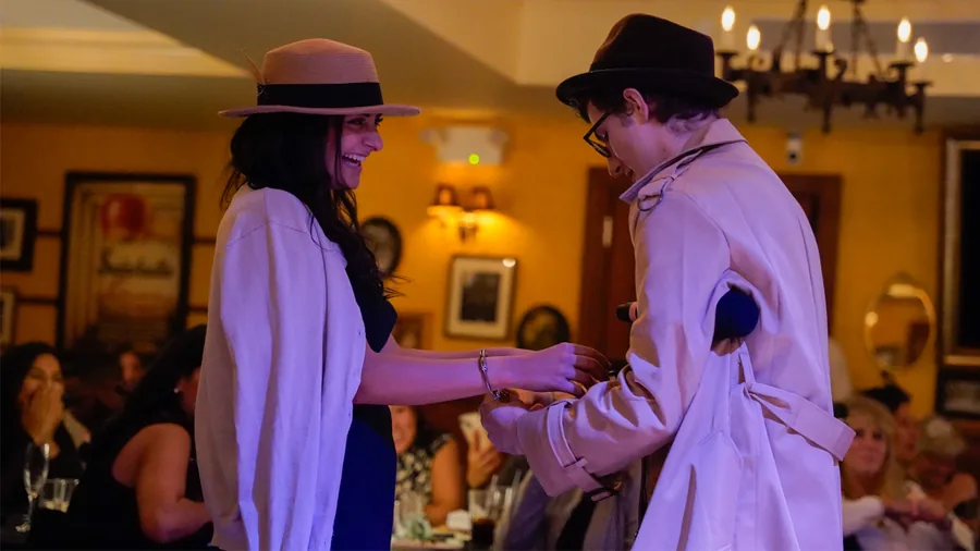 A Murder Mystery Company detective questioning a guest at a St. Louis show