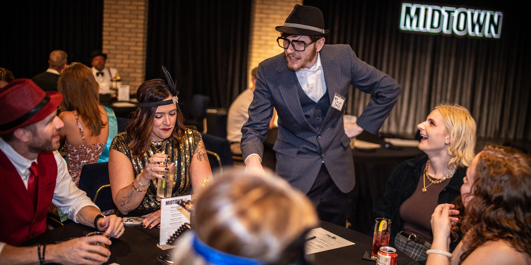 Guests at a Murder Mystery Company public dinner show in St. Louis